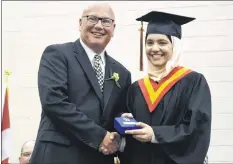  ?? CHRIS SAULNIER ?? Douah Shakshuki received the Governor General’s Academic Medal, presented by vice-principal Kevin Carver. The medal is awarded for having the highest combined average for Grade 11 and 12 courses. Her average was 99.8 per cent.