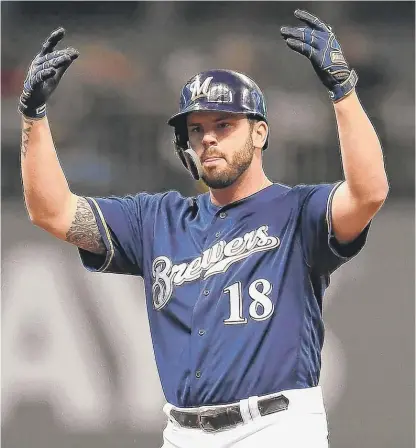  ?? GETTY IMAGES ?? Mike Moustakas celebrates after hitting a double in the fourth inning. The Brewers can clinch the NLDS with a win Sunday.