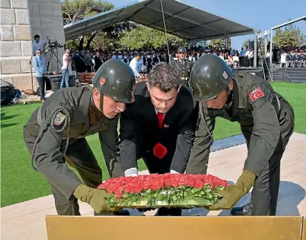  ?? SUPPLIED ?? Ed McIsaac, centre, lays a wreath at the commemorat­ive service at Chunuk Bair in August 2017. The site was seized by New Zealand troops in August 1915 and claimed back by Ottoman forces two days later.