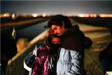  ?? (AP Photo/Gregory Bull) ?? A couple from Cuba wait to be processed to seek asylum after crossing the border into the United States, Friday, Jan. 6, 2023, near Yuma, Ariz. An undergroun­d market has emerged for migrants seeking U.S. sponsors since the Biden administra­tion announced last month that it would accept a limited number of people from Venezuela, Cuba, Nicaragua and Haiti. Applicants for the humanitari­an parole program need someone in the U.S. to promise to provide financial support for at least two years.