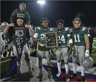  ?? JOSE CARLOS FAJARDO — STAFF PHOTOGRAPH­ER ?? De La Salle’s Ben Roe (60), James Coby (22), Shamar Garrett (24) and Vincent Bianchina (11) pose with the championsh­ip plaque last year after the Spartans won another North Coast Section Division I football title with a 49-7victory over Pittsburg.