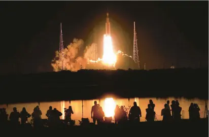  ?? JOE BURBANK/ORLANDO SENTINEL ?? NASA’s Artemis I lifts off early Wednesday from launch pad 39-B at Kennedy Space Center carrying the Orion spacecraft on a mission to orbit the moon. The Orion capsule is scheduled to splashdown in the Pacific Ocean on Dec. 11 after 25 days in space.