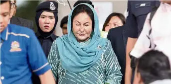  ??  ?? Claiming trial: Rosmah leaving court after being charged in Kuala Lumpur.