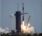  ?? CHRIS O'MEARA — THE ASSOCIATED PRESS ?? A SpaceX Falcon 9 rocket with the Crew Dragon capsule attached, lifts off with the first private crew on Friday.