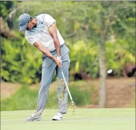  ?? John Raoux Associated Press ?? TIGER WOODS’ best round of the year, a seven-under 65, was only good enough to cut his deficit from 14 shots to 11 behind Simpson entering the final round.