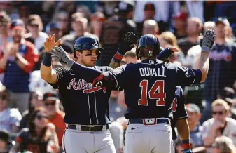  ?? Lachlan Cunningham / Getty Images ?? Adam Duvall is greeted at home by Atlanta teammate Austin Riley after Duvall’s two-run homer off Anthony DeSclafani gave the Braves a 2-0 lead in the seventh inning at Oracle Park.