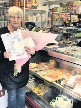  ??  ?? Thank you
Helen Whyte was given flowers by members of the communitys