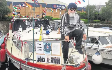  ?? 14376915 ?? John MacKebitt, dressed as a burglar for fun, aboard his boat called the Sleeping Tiger