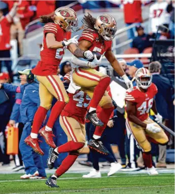  ?? Carlos Avila Gonzalez/The Chronicle ?? Linebacker Fred Warner (center) and safety Talanoa Hufanga (left) celebrate Warner’s intercepti­on in the first half of the 49ers’ divisional win over the Cowboys last Sunday.