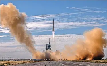  ?? | EPA ?? THE Long March-2F carrier rocket, carrying the Shenzhou-12, takes off from the launch site at the Jiuquan Satellite Launch Center in the Gobi Desert, Inner Mongolia, near Jiuquan, China yesterday.