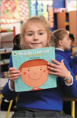  ??  ?? Arina Sucaci from Senior Infants pictured all smiles showing us her current library book.