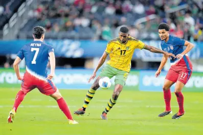  ?? AP ?? Jamaica’s Damion Lowe (centre) controls th ball against United States’ Malik Tillman (right) and Gio Reyna (left) during the second half of a Concacaf Nations League semifinal match on Thursday, March 21, 2024, in Arlington, Texas.