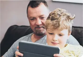  ??  ?? Dad and son with iPad.