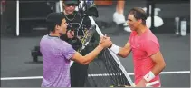  ?? GETTY IMAGES VIA AFP ?? Carlos Alcaraz (left) and Rafael Nadal greet each other at the Netflix Slam in Las Vegas on Sunday.