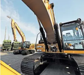  ?? TED S. WARREN/AP ?? Farm and constructi­on equipment are prepped Tuesday to be exported to Asia from the Port of Tacoma in Washington state. U.S. exports fell to $206 billion in September.