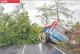  ?? AFP ?? ■
A truck is damaged and trees are uprooted Raigad district’s Alibag. ALIBAG