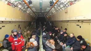  ??  ?? Recently exchanged Ukrainians sit in an aircraft at an airport outside Kharkiv following a prisoner exchange between Ukraine and pro-Russian rebels yesterday.