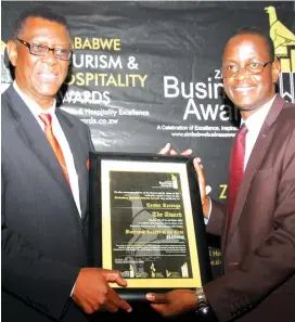  ??  ?? Insurance and Pensions Commission Commission­er, Tendai Karonga (left) and IPEC public relations officer Lloyd Gumbo show the Business Leader of the Year (National) Award won by Mr Karonga at a local hotel in Harare yesterday. The awards are organised...