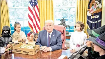  ??  ?? President Trump meets with children of members of the press for Halloween in the Oval Office of the White House in Washington, DC, on Friday. — AFP photo