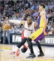  ?? Joel Auerbach
Associated Press ?? JORDAN CLARKSON of the Lakers tries to deal with a driving Dwyane Wade of Miami.
