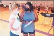  ?? Joe Morelli / Hearst Connecticu­t Media ?? Career girls volleyball coach Nally Sahin, right, provides some instructio­n to junior Daneris Tirado during practice.