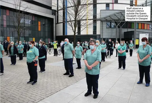  ??  ?? Staff observe a minute’s silence outside the Queen Elizabeth University Hospital in Glasgow