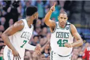  ?? DWYER/THE ASSOCIATED PRESS] [MICHAEL ?? Boston Celtics forward Al Horford (42) celebrates a made basket with guard Jaylen Brown (7) during the first quarter of Game 1 of the NBA Eastern Conference Finals against the Cleveland Cavaliers on Sunday in Boston.