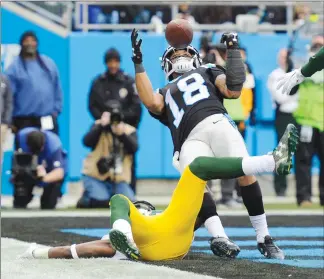  ?? Associated Press photo ?? Carolina Panthers’ Damiere Byrd (18) catches a touchdown pass over Green Bay Packers’ Josh Hawkins (28) during the second half of an NFL football game in Charlotte, N.C., Sunday.