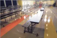  ?? Ned Gerard / Hearst Connecticu­t Media ?? Cafeteria tables have been cut in half at Johnson School in Bridgeport so that students will all sit facing in one direction.