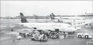  ?? DANIEL KRIEGER / THE NEW YORK TIMES ?? Planes are parked in February 2016 at Delta Air Lines gates at John F. Kennedy Internatio­nal Airport in New York. Starting in 2018, the government will begin counting f lights operated by the big airlines’ regional partners — f lights more prone to delays — for its on-time f light statistics.