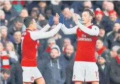  ??  ?? Arsenal’s Alexis Sanchez celebrates after scoring a goal with Mesut Ozil in this file photo. — Reuters photo