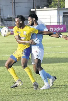  ?? ?? Molynes United’s Damion Thomas fends off a challenge from Waterhouse’s Jahvon James during their Jamaica Premier League contest at Anthony Spaulding Sports Complex on Monday.