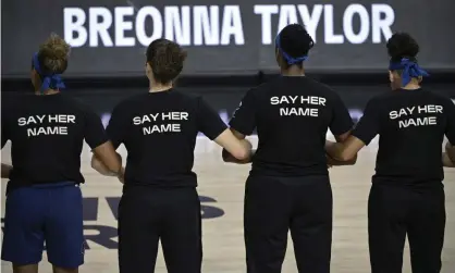  ?? Photograph: Phelan M Ebenhack/AP ?? Minnesota Lynx players lock arms during a moment of silence in honor of Breonna Taylor before a game against the Connecticu­t Sun last summer in the WNBA bubble in Bradenton, Florida.