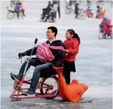  ??  ?? February 4, 2017: Kids and their parents enjoy riding on the frozen Shichahai Lake in Beijing. VCG