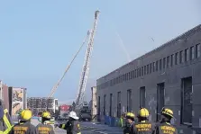  ?? JEFF CHIU/ASSOCIATED PRESS ?? A firefighte­r sprays into a warehouse after a fire broke out before dawn at Fisherman’s Wharf in San Francisco on Saturday. Fire officials said no injuries were reported.