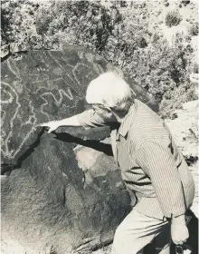  ??  ?? Archaeolog­ist Janet MacKenzie discusses ancient markings at the Wells Petroglyph Preserve; photo Paul Weideman