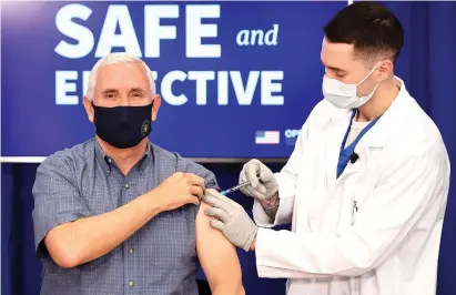  ?? Saul Loeb/ AFP via Getty
Images ?? ABOVE: U.S. Vice President Mike Pence
receives the COVID19 vaccine Friday in the Eisenhower Executive
Office Building in Washington,
D.C.,