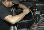  ?? ??  After installing the bottom inlet plug (Richards recommends running the plug to prevent water intrusion with the frequent heavy rain seen in the Tennessee area) and silicone tube seal, he carefully lowers the new air box into position in the truck.