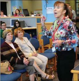 ?? Ernest A. Brown photo ?? Pauline Welsh, left, and Rachel Bowditch, both of Bellingham, listen to second-generation Holocaust survivor Monika Curnett, right, during her presentati­on to Frederick W. Hartnett Middle School 8th graders in the school’s media center Friday. The two...