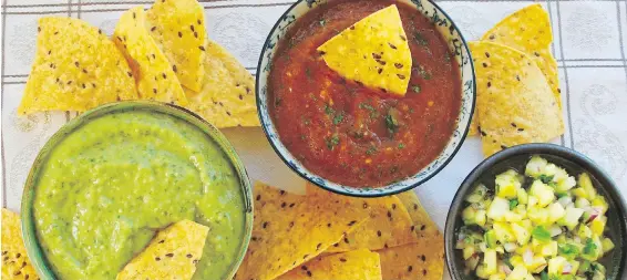  ??  ?? Three homemade salsas, served with chips for dunking, from left: Guacamole Taquero, Roasted Tomato and Jalapeño Salsa and Fresh Pineapple Salsa.