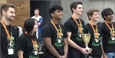  ?? SUBMITTED PHOTO ?? Novi celebrates with the championsh­ip trophy after they defeated Muskegon Mona Shores during the League of Legends esports fall state championsh­ip which was held at Oakland University recently.