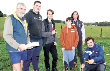  ??  ?? Cannibal Creek Catchment Landcare Group member Charlie Rupe (left) and Pakenham Secondary school teacher Allison Barrie assist students in the tree planting program (from left): Mason Barbour, Tyson Alie Alex Chapman and Codey Whalley.