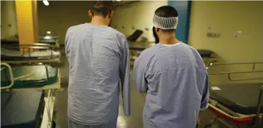  ??  ?? Syrian patients, who were wounded in the ongoing violence in Syria, stand in a hospital ward in Nahariya, Israel. (AFP)