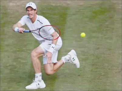  ?? The Associated Press ?? Britain’s Andy Murray returns to Italy’s Fabio Fognini during their men’s singles match at the Wimbledon Tennis Championsh­ips in London, England, on Friday. Murray won 6-2, 4-6, 6-1, 7-5.