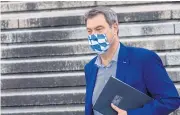  ?? AFP ?? Bavaria premier Markus Soeder walks over the stone staircase of the State Chanceller­y prior the Bavarian cabinet meeting in July in Munich.