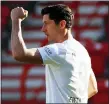  ?? HANNIBAL HANSCHKE — AP ?? Bayern Munich Robert Lewandowsk­i of celebrates his opening goal during the German Bundesliga match against Union Berlin on Sunday. Bundesliga becomes the world’s first major soccer league to resume games.