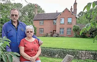  ??  ?? Heartache: Anne and Ron Ryall in the garden of their beloved house