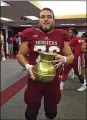  ??  ?? Wes Martin holds the coveted golden spittoon after an IU victory over Michigan State. Martin was an All-Big Ten guard.