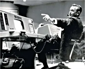  ??  ?? Kraft, above, at his post during the Project Mercury programme, and below, handing out cigars following the successful splashdown at the end of the Apollo 11 mission