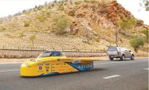  ??  ?? EPIC RACE – The University of Michigan’s ‘Novum’ zips along Alicia Springs, a remote town between Darwin and Adelaide, on Tuesday, while taking part in the World Solar Challenge, a 3,000-kilometer solar car race across outback Australia.